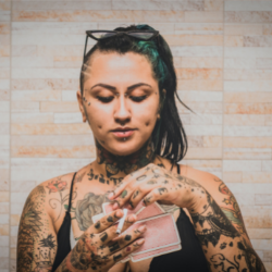 Woman with tattoos playing cards